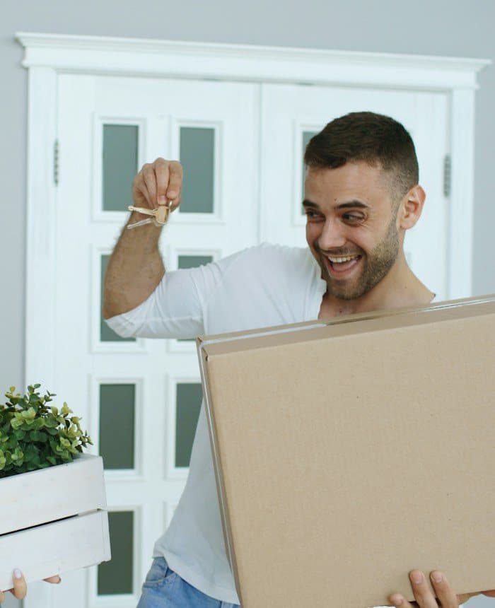 Happy couple settling into their new home with moving boxes