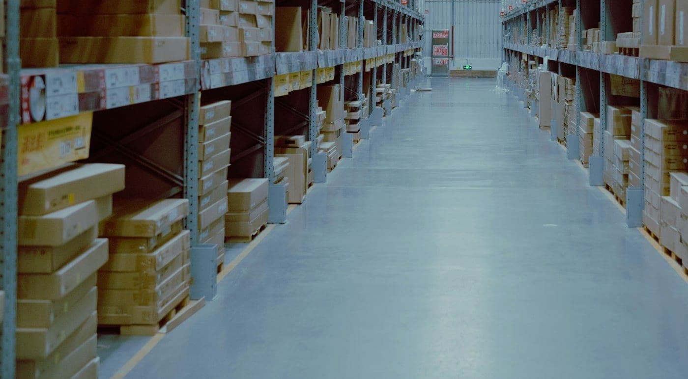 Warehouse aisle with racks of packed cartons in storage
